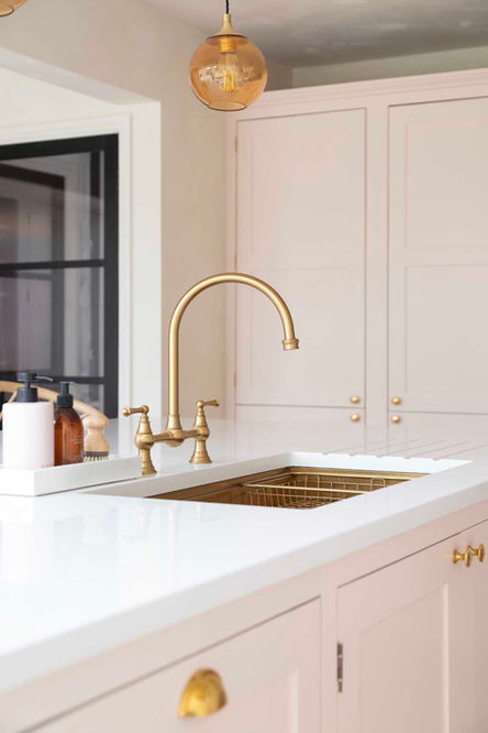 Brass traditional tap, pink kitchen, shaker cabinets