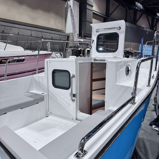 Mid-cockpit on the SeaPiper showing access to forecabin, foredeck, and built-in seating.