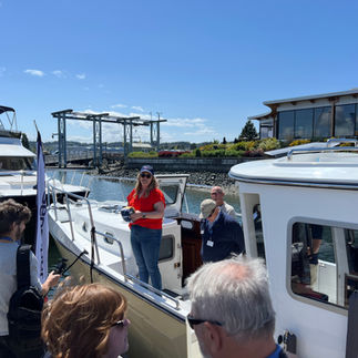 Marketing Lead Mallory Parks welcomes onlookers to SeaPiper 37 celebration