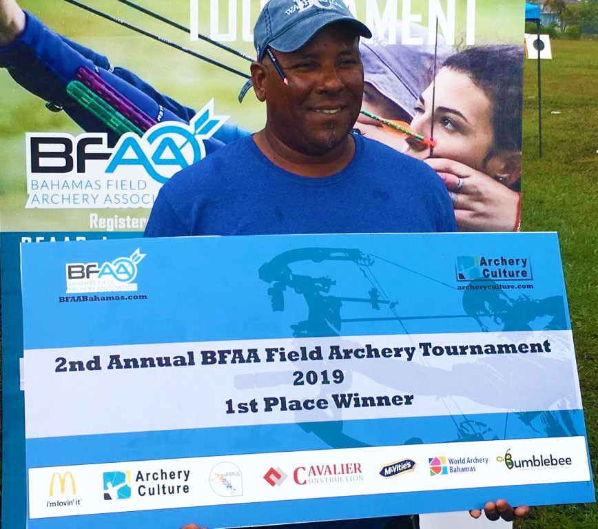 Tasso Roker holding presentation cheque