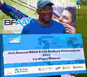 Tasso Roker holding presentation cheque
