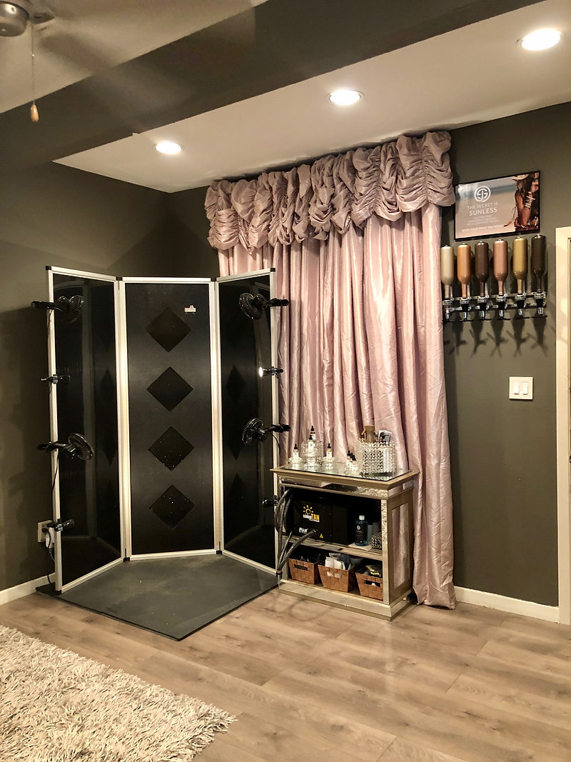 Spray tan booth and product bar in the salon room