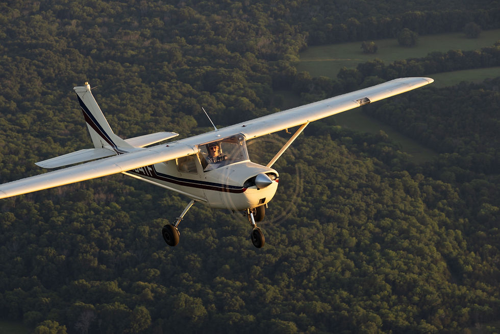 Small plane from a flight school in Lebanon TN flying over trees.