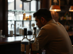 A sad man alone at a bar
