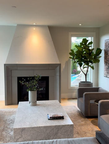 Fiddle leaf fig styled beside a fireplace in a modern Vancouver living room with professional plant care services available