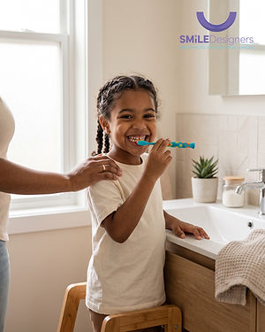Young girl brushing her teeth with a parent at a bathroom sink, with the Smile Designers Dentistry logo