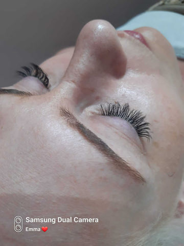 Above view of women's face with eyelash extensions 