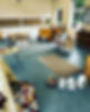 Preschool play area with table and chairs, a tent, and a rug