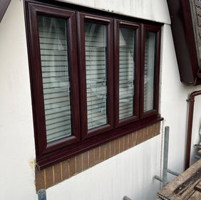 Brown windows on front of white house