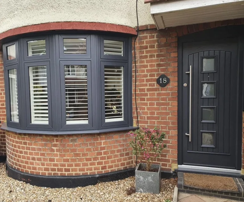 House exterior with black window shutters and door