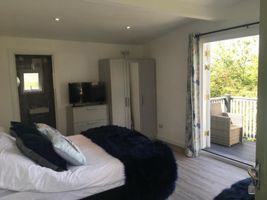 Hotel room interior with single bed and balcony