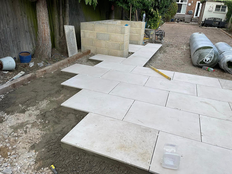 White patio tiles being added to garden