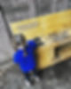 Little girl in blue uniform stood in front of Robins Nest Preschool wood cabinet