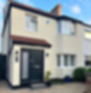 House exterior with white and black design and white window shutters 