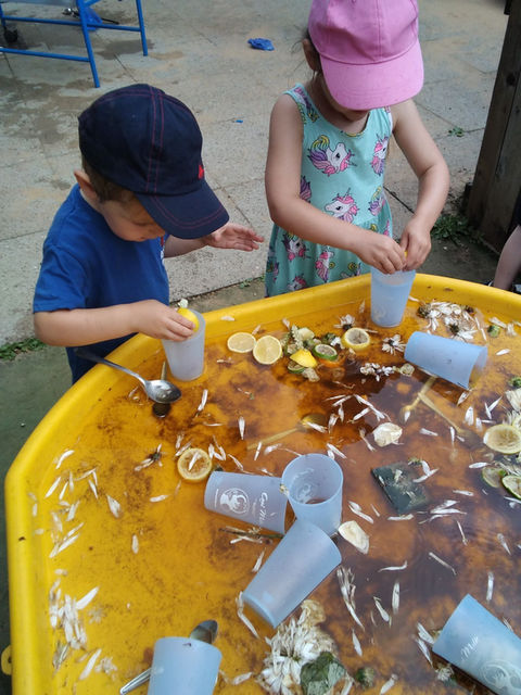 Two children playing plastic cups 