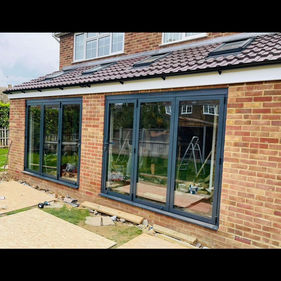 Large black rimmed windows on side of house