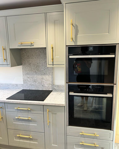 Kitchen interior with white cupboards and gold handles