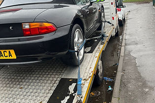 Black car being towed