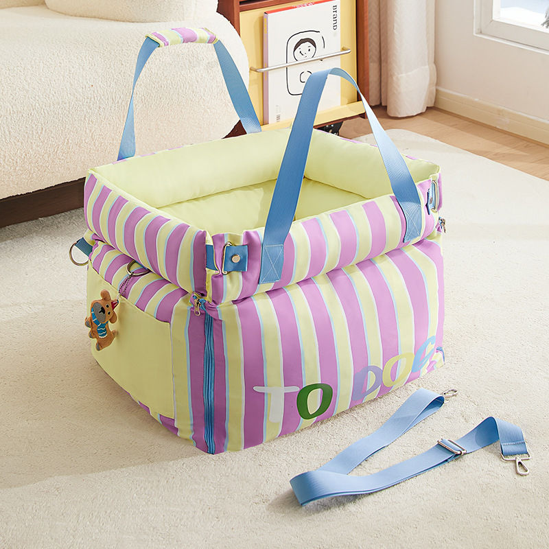 Pastel striped portable dog carrier bed with blue hand straps, detachable crossbody shoulder strap and cute dog zipper charm 