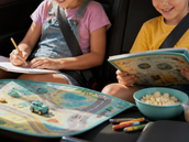 Two kids in the car with activities