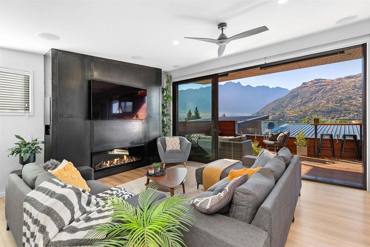 a living room with a fireplace and a flat screen tv