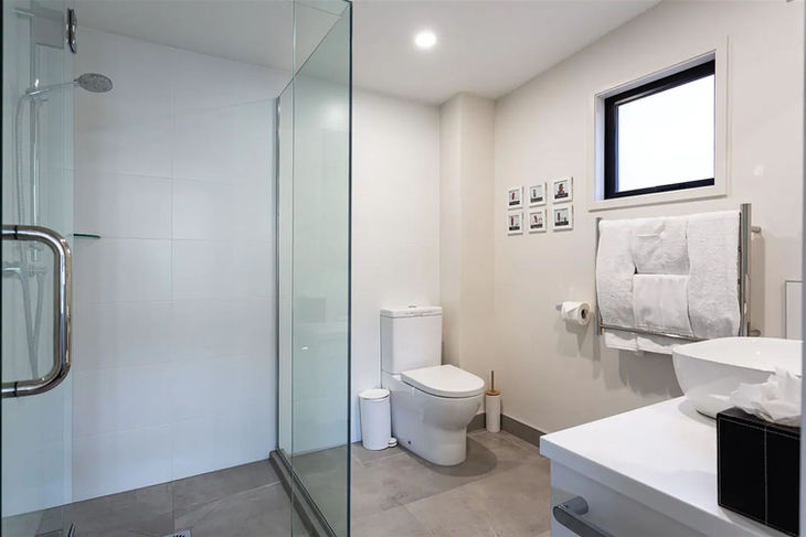 a bathroom with a toilet and a walk in shower