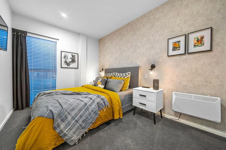 a bedroom with a large bed and two nightstands