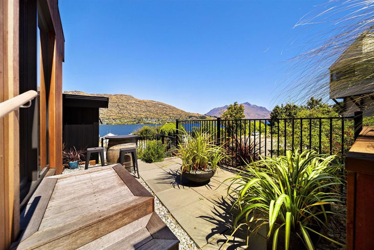 a patio with a view of a lake and mountains