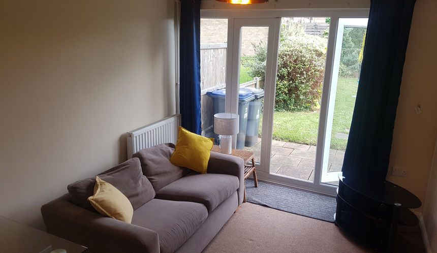 Separate lounge in this 4 bed student house on a quiet green. With patio doors to the garden. Modern Furniture, including glass table and chairs, 2 sofas, bookcase and TV.