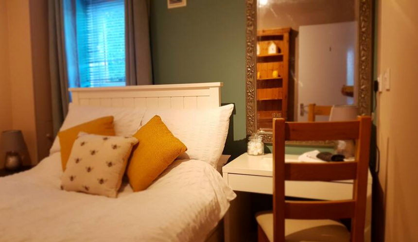 Bedroom 1 in this modern student house close to UKC. Benefits from a built in wardrobe, feature wall and double bed. 