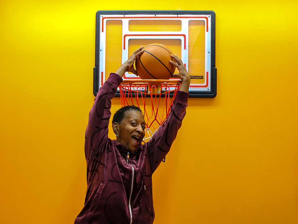 Fashion and Business Happy Hour attendee shooting hoops