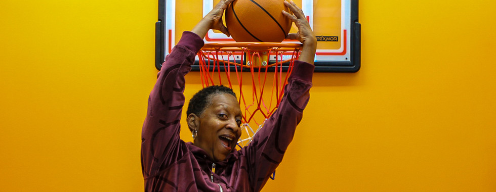 Fashion and Business Happy Hour attendee shooting hoops