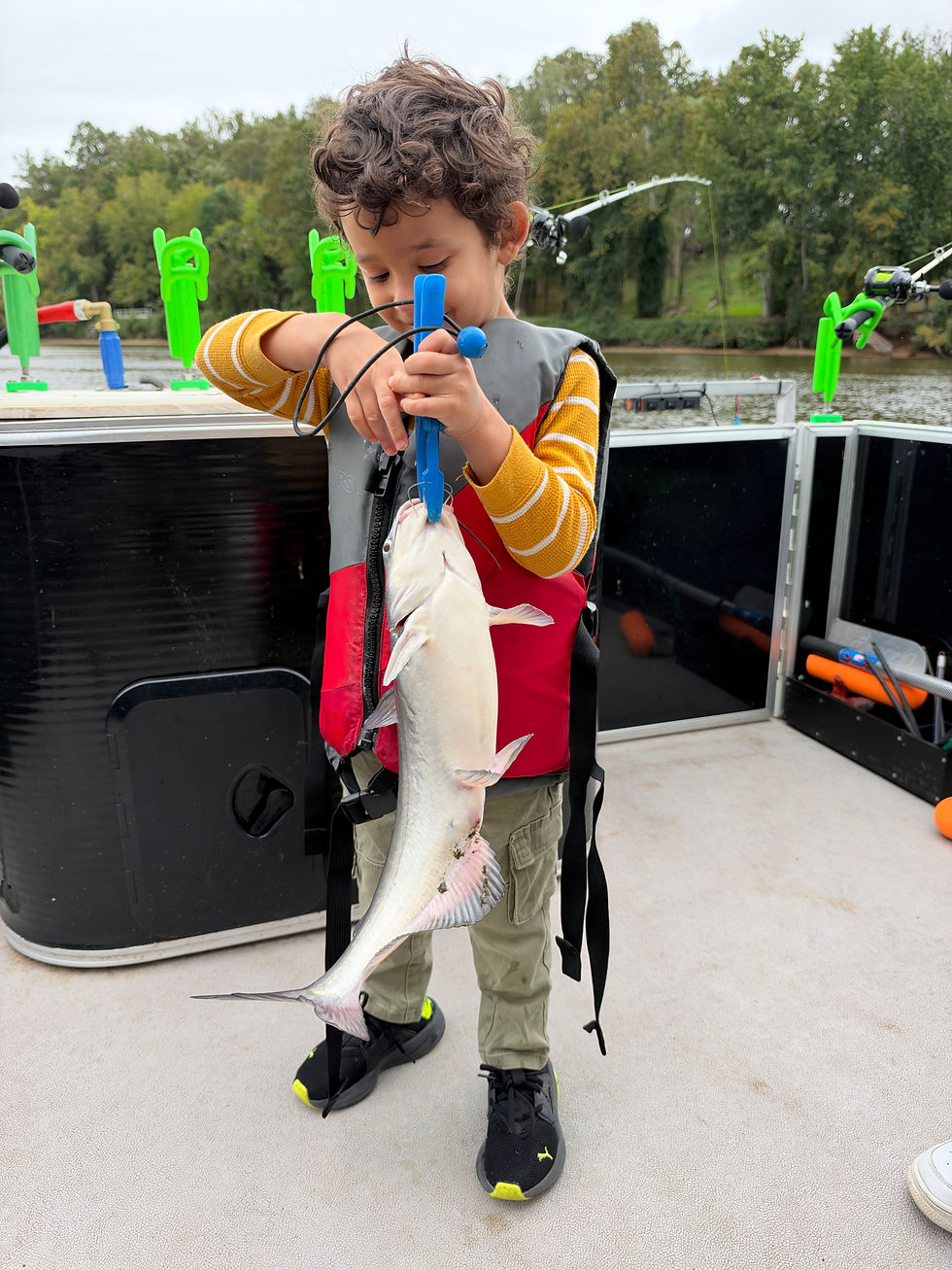 Young angler holding blue catfish caught with Goober Time Guide Service while on the James River.