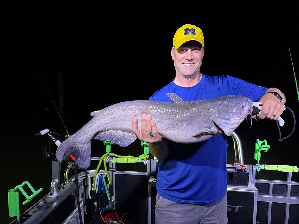 Angler showing off blue catfish caught while fishing the James River with Goober Time Guide Service