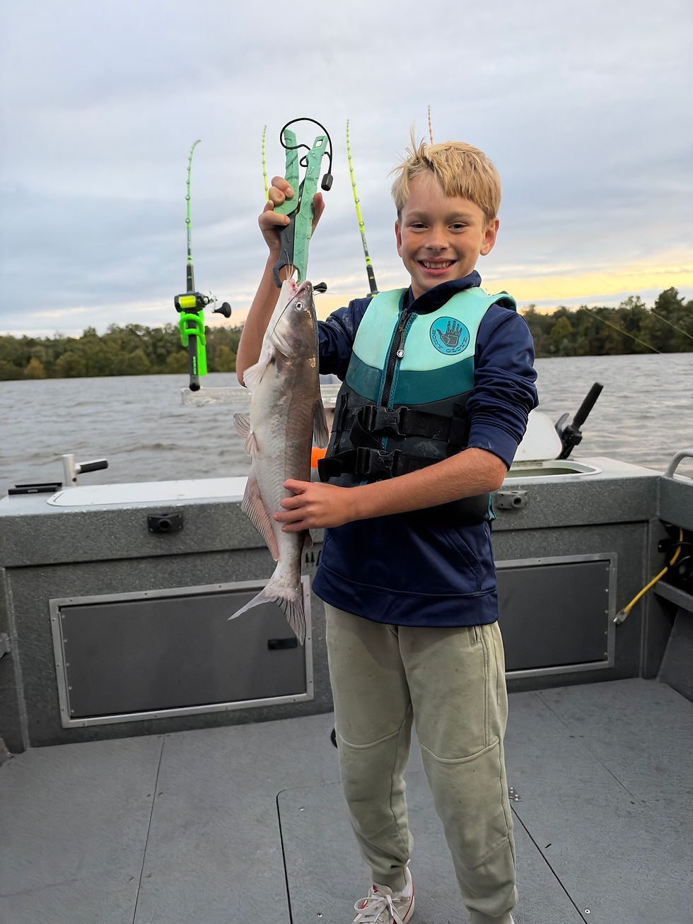 Young boy holding 2 lb blue catfish caught while fishing on the James River with Goober Time Guide Service.