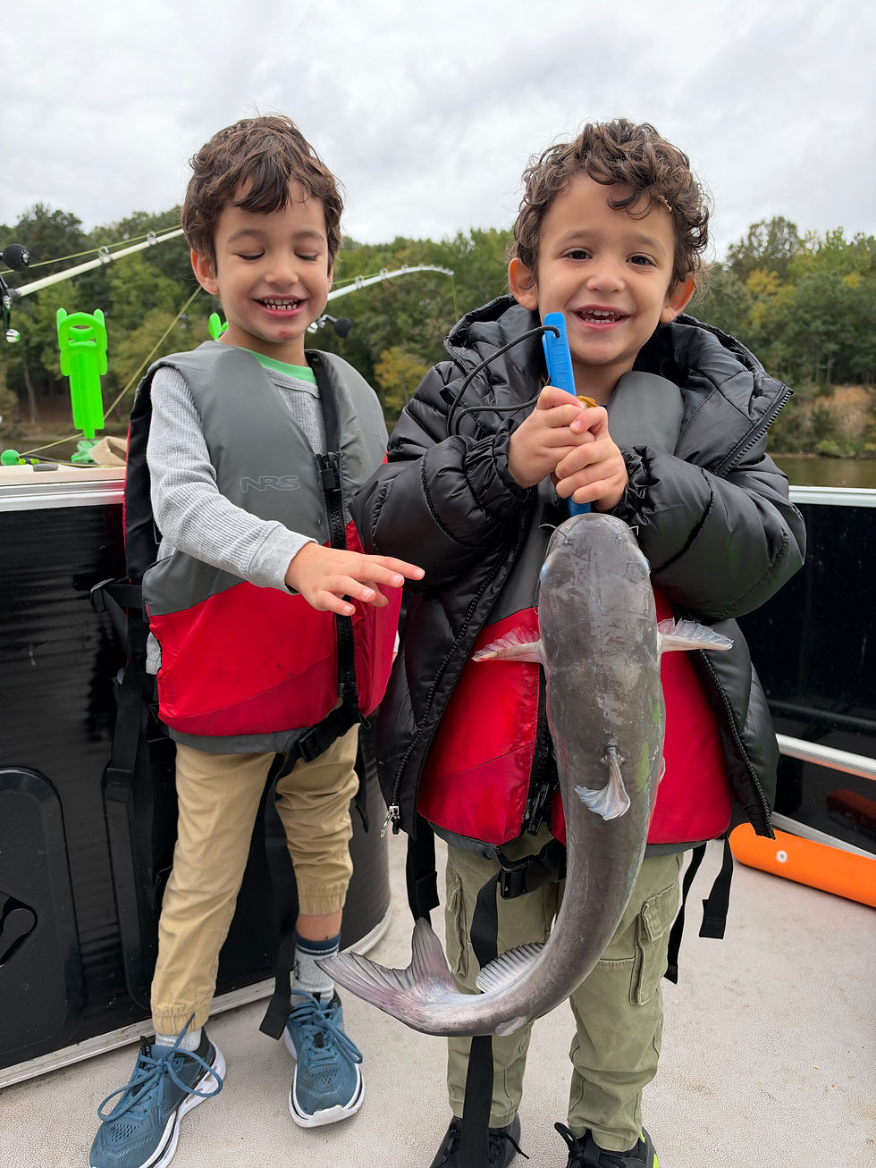 Young anglers holding blue catfish caught with Goober Time Guide Service while on the James River.