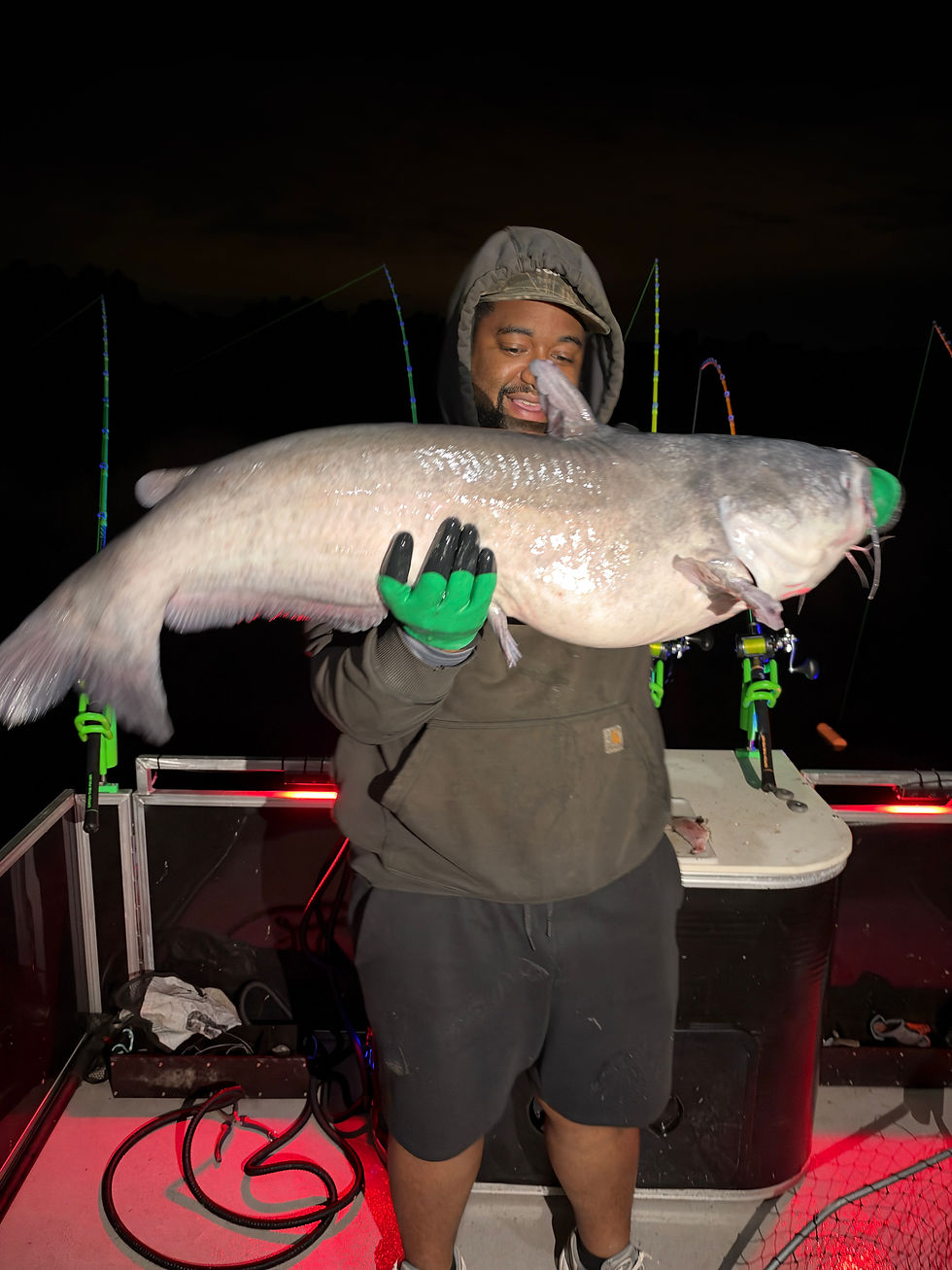 Angler holding large blue catfish caught on the James River with Goober Time Guide Service