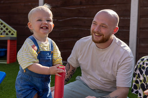 Smiley child and dad playing
