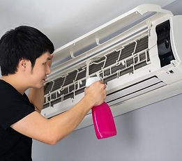 Premium Photo _ Worker to cleaning coil cooler of air conditioner.jpeg