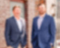 Picture of leadership standing in front of brick building