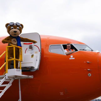 Sunny bear and pilot at 2023 Sun Country plane pull