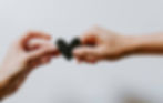 Person giving a heart to another person