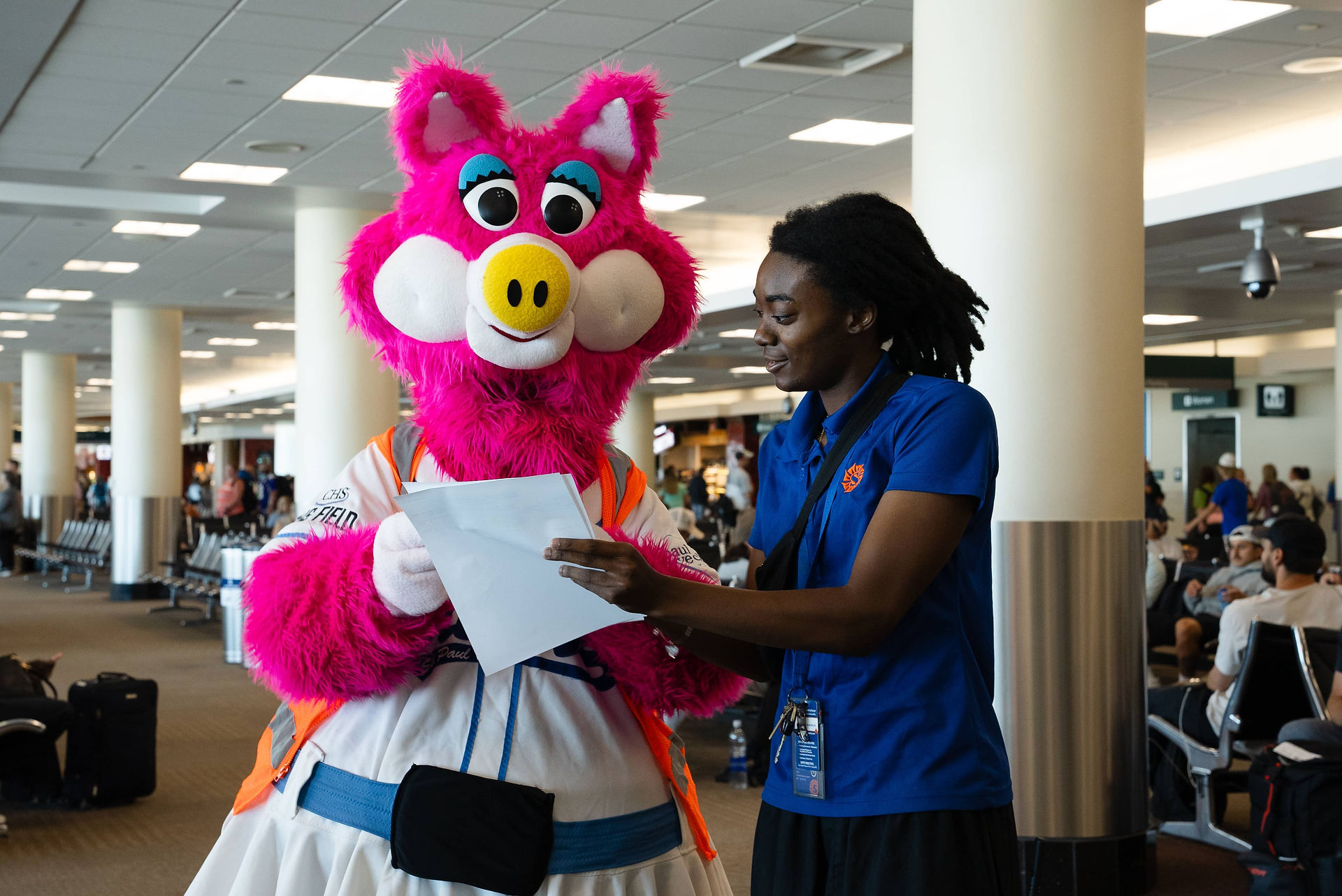 Saints mascot, Mudonna, conversing with Sun Country worker before flight