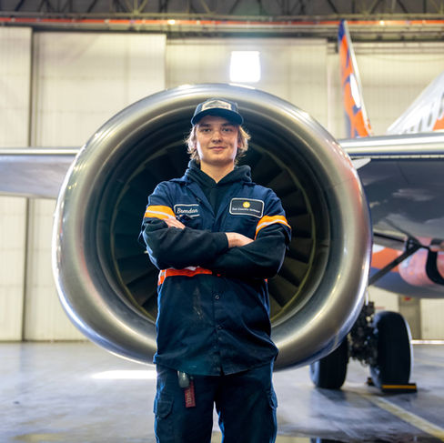 Brendan posing in front of an aircraft