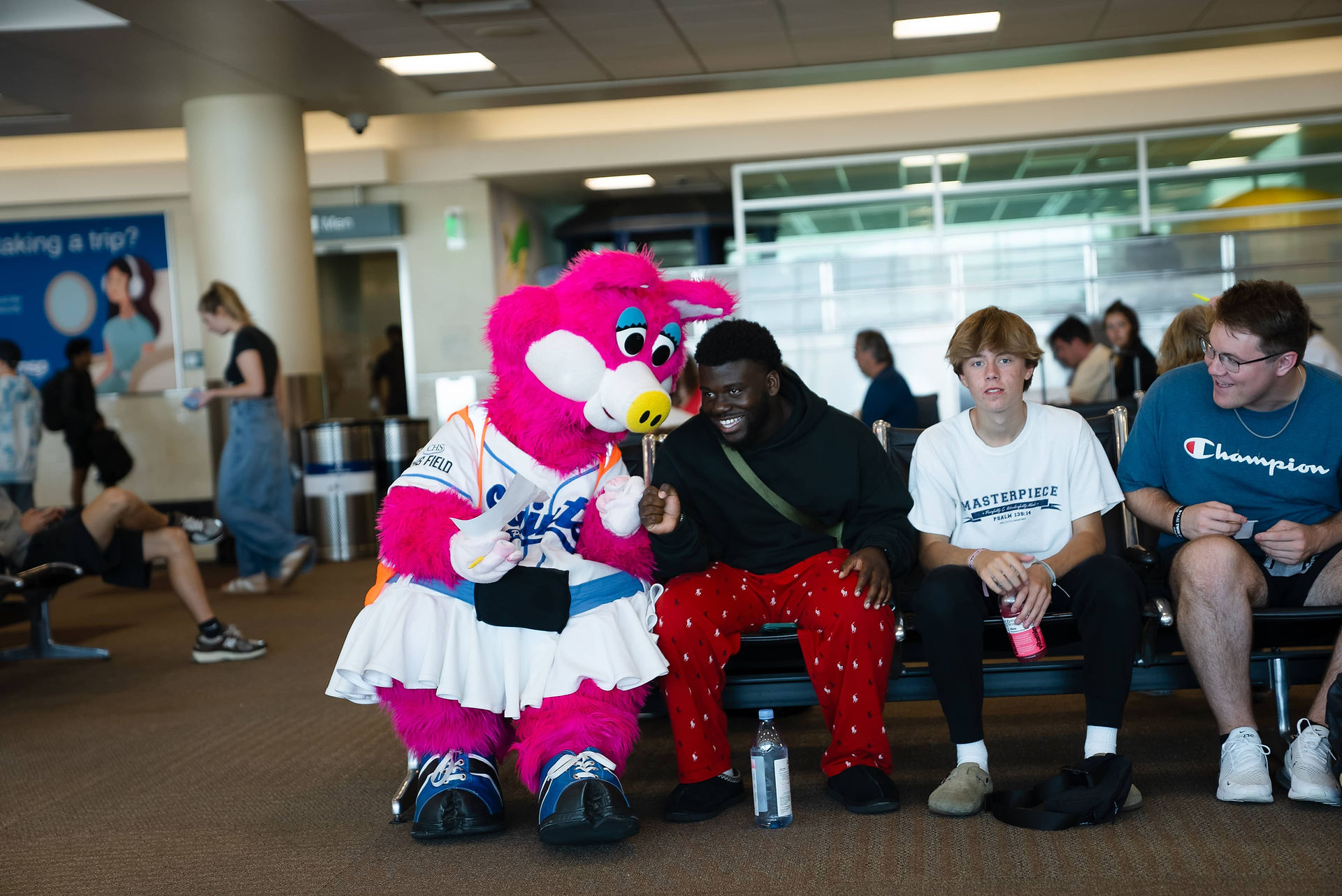 Saints mascot, Mudonna, giving Sun Country passengers knuckles.