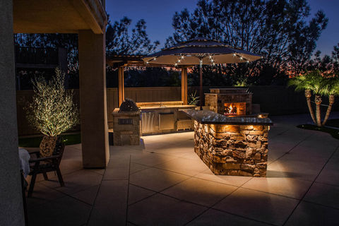 complete outdoor living and entertainment area with custom designed stone Fireplace, Built in Grill and counter space for seating and cooking counterspace with Granite and decorative concrete work