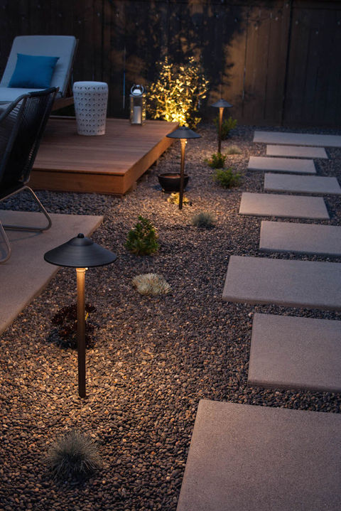 hardscape pathway with concrete squares and gravel, landscape lighting and deck