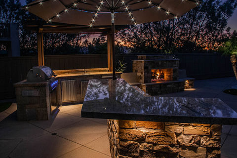 Backyard Outdoor living space and entertainment area with custom designed and built outdoor fireplace,  Landscape Hardscape Design Build
