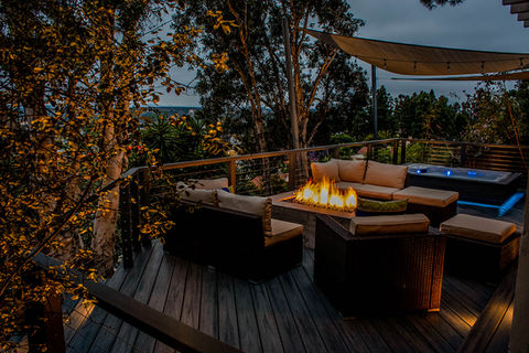 Custom Backyard deck with fire pit and spa built into deck, stainless steel cable handrailing, trex deck with steps, stairs and lighting