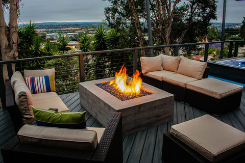 Custom concrete Fire Pit built into composite deck with spa and lounge entertainment area 